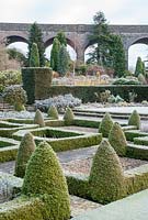 Box parterre in winter with viaduct in background - Kilver Court, Somerset