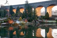 Sunrise through the viaduct with reflection on the lake - Kilver Court Garden, Somerset