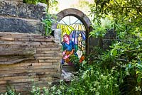 Stained glass window in stone folly - The Evaders garden. RHS Chelsea Flower Show, 2015