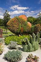 Living plant sculptures in summer called 'Small Clownfish and Anemone' created on metal mesh forms filled with earth and planted with various plants and grasses. Montreal Botanical Garden, Montreal, Quebec, Canada