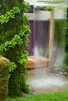 Contemporary garden with water feature and living green walls of foliage plants and moss. Home - Personal Universe Garden by T's Garden Square.  RHS Chelsea Flower Show, 2015