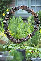 The Great Chelsea Garden Challenge. Circular sculpture made from rusted old steel cans.