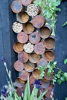 The Great Chelsea  Garden Challenge garden - old rusty tin cans and insect hotel, bee wildlife friendly habitat 
