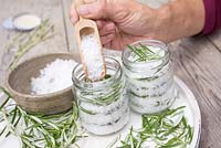 In glass jars create layers of sea salt then rosemary leaves until the jar is full