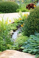 Curved water rill with Equisetum japonicum, ferns, Hosta 'Elegans', Taxus baccata and Trollius chinensis 'Golden Queen' - Encore: A Music Lover's Garden, RHS Hampton Court Palace Flower Show 2015