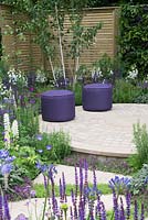 Purple stools on circular paving - The Wellbeing of Woman Garden, RHS Hampton Court Palace Flower Show 2015 - Design: Wendy von Buren, Claire Moreno, Amy Robertson