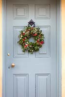 Christmas wreath hanging on Duck egg blue door. 