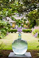 Bottle sculpture on plinth. View to back of house. Orchard House, Sedbury, Gloucestershire. June 2015. 