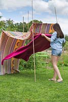 Lay down a colourful rug to rest on underneath your canopy