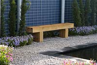 Wooden bench in minimal garden