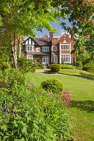 Beacon Garth - an Edwardian, Arts and Crafts house fronted by a sloping lawn 
