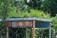 Living roof and insect hotels above the bicycle shed - Gardeners' Question Time garden, Hampton Court Palace Flower Show 2015