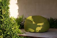 The Macmillan Legacy Garden - contemporary garden shelter with living walls planted with woodland plants, ferns and ivy, raised terrace with green outdoor seat and cushion - Designer Ann Marie Powell - Sponsor Macmillan Cancer Support - RHS Hampton Court Flower Show 2015 - awarded Gold