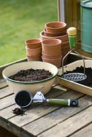 Planting up enamel container using vintage kitchen tools