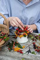 Hips and berries posie step by step in November. Adding stems of rosehips alongside berries of hawthorn, pyracantha and cotoneaster.
