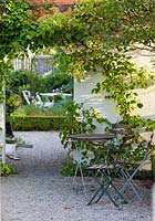 Garden furniture and Hydrangea anomala ssp. petiolaris - early August - Private garden, Malmo, Sweden