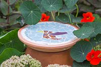 Mosaic bird bath made from broken tiles
