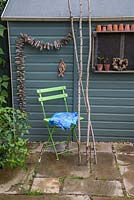Materials required for creating a blue shaded awning. Hazel sticks, fabric, screw eyes and string