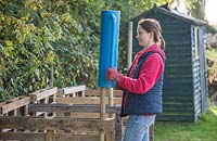 Use a post driver to secure your wooden stakes firmly into the ground