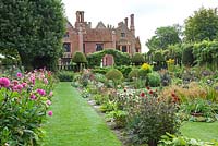 Chenies Manor Gardens - Showing the House and Sunken Garden double borders with Dahlia and perennials