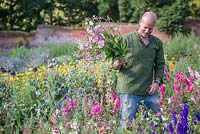 Patrick Cadman holding a bunch of freshly cut Nicotiana flowers