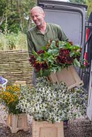 Patrick Cadman unloading containers of cut flowers back at the workshop