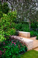 Centenary Homebase garden. Sowing The Seeds of Change. Gold medal. Family garden with integrated vegetable, herbs and Pyrus tree. Design: Adam Frost Sponsor: Homebase
