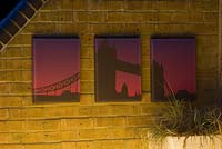 Outdoor weather proof canvas prints on brick wall with lighting on Wapping Balcony