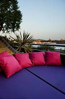 Contemporary balcony overlooking the Thames at Wapping with colourful soft furnishing 