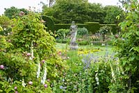 Formal garden with statue of Flora with borders - Helmingham Hall, Suffolk