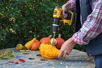 Use the drill with the wood spade or paddle bits attached and drill into the centre of the Gourd