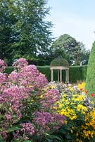The Long Border with Eupatorium, Rudbeckia nitida 'Herbstsonne' and Ionic Temple in background - Forde Abbey, Somerset