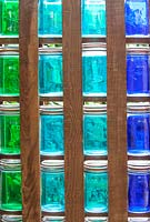 Decorative colour glasses as wall. 