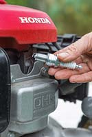 Use a socket and spanner set to fit a brand new spark plug