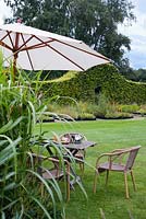 Relaxing area by the border of grasses and perennials. De Buitenhof garden in October