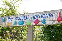 Coastal Gardener sign with reclaimed material from the beach