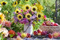 Floral and harvest display of Asters, Sunflowers and Apples.