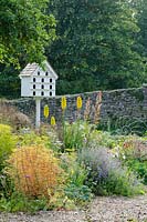 Dovecote by Gerry Peachey, Verbena bonariensis, Kniphofia 'Green Jade', Macleya cordata, Nepeta and Euphorbia 'Golden Foam' - The Walled Garden at Mells, Somerset
