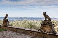 View to Florence from terrace of Villa. Statues of hounds on wall. Villa Gamberaia, Settignano, nr Florence, Tuscany, Italy. Septmber.
