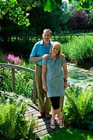 Portrait of owners David and Clodagh Dugdale standing on a wooden bridge