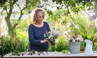 Gabi Reid creating a flower arrangement from her cutting garden with late flowering flowers. September.