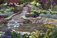The pond and waterfall in the centre of 'The Water Garden' at RHS Tatton Flower Show 2015