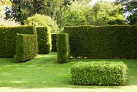 Geometric shapes of clipped Yew hedges and a cube of Hedera - Ivy. Designer Georgia Langton. Farleigh House, Hampshire.