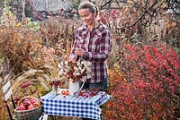 Creating a Floral display with dried perennial flowers in November: rosehips, honesty, Sedum, Aster, Persicaria