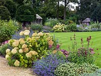 The garden at Bretforton Manor, planting includes Hydrangea arborescens 'Annabelle', Nepeta 'Walker's Low', Penstemon 'Rich Ruby', Sedum 'Matrona' and Caryopteris.