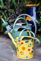 A selection of metal watering cans.