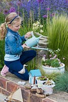 Planting a seaside container step by step: Step 6: Water thoroughly.