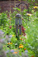 Wind chime used as bird scarer in a vegetable garden to protect crops in a vegetable garden