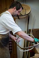 Charlie Groves making a traditional Sussex trug. Tweaking the handle and rim of the trug.