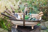 Seeds and planting tools in a traditional handmade Sussex trug made by Charlie Groves.